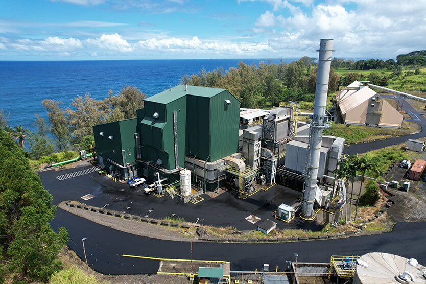 Overhead view of the facility with the ocean in the background.